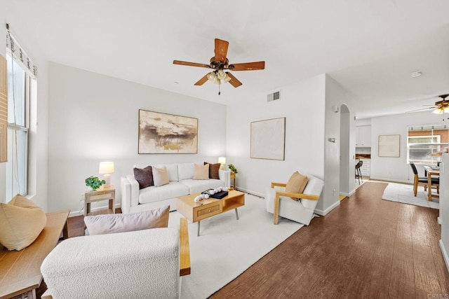 1295 Blue Jean Way Unit 2, Chula Vista, CA 91913 - living area featuring a ceiling fan, visible vents, arched walkways, wood finished floors, and baseboards