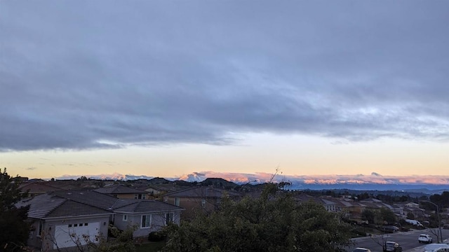 view of mountain background featuring nearby suburban area