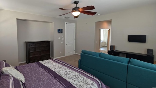 carpeted bedroom featuring baseboards and ceiling fan