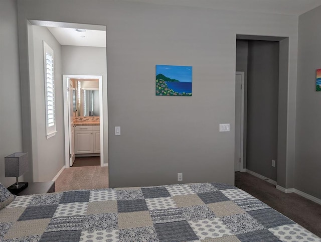 bedroom featuring carpet flooring, baseboards, and ensuite bath