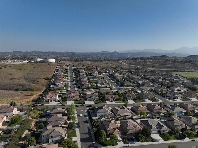view of property location with a mountain backdrop and nearby suburban area