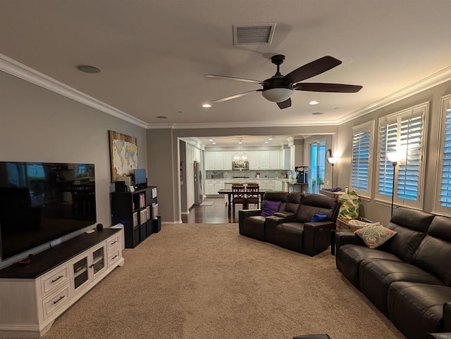 living area featuring a ceiling fan, ornamental molding, carpet floors, and recessed lighting