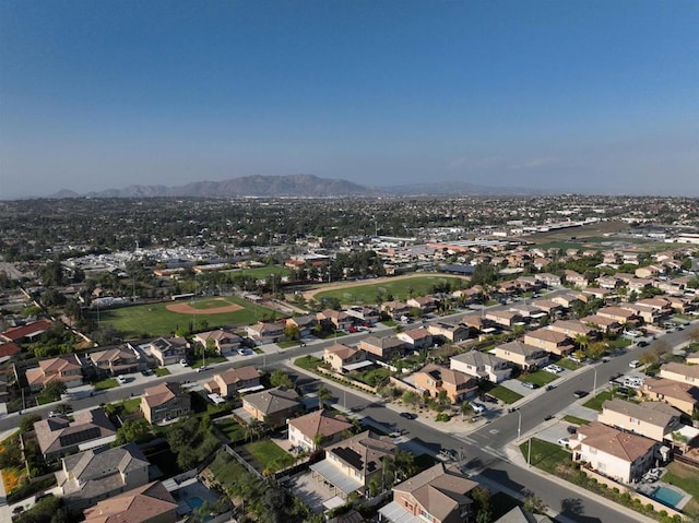 aerial overview of property's location featuring a mountain backdrop and nearby suburban area