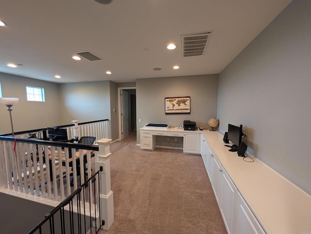 home office featuring light carpet, built in desk, and recessed lighting
