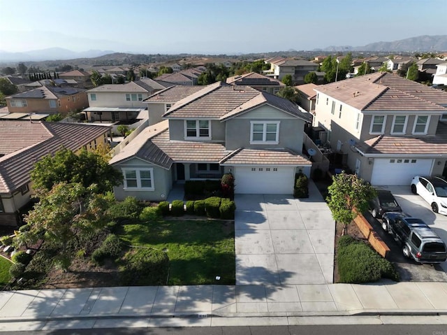aerial view of residential area featuring a mountainous background