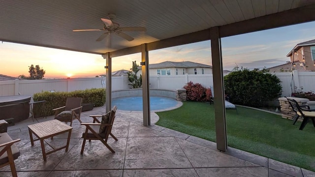 view of patio / terrace with a fenced backyard, a hot tub, and a ceiling fan