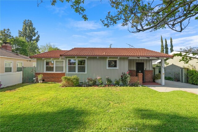 15731 Marlin Pl, Van Nuys, CA 91406 - ranch-style home with board and batten siding, brick siding, fence, and a front yard
