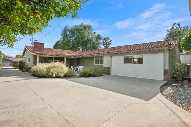 15731 Marlin Pl, Van Nuys, CA 91406 - single story home with a chimney, concrete driveway, a tile roof, and brick siding