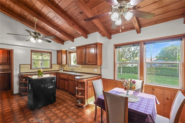 15731 Marlin Pl, Van Nuys, CA 91406 - kitchen featuring brown cabinetry, a ceiling fan, vaulted ceiling with beams, a kitchen island, and wood ceiling
