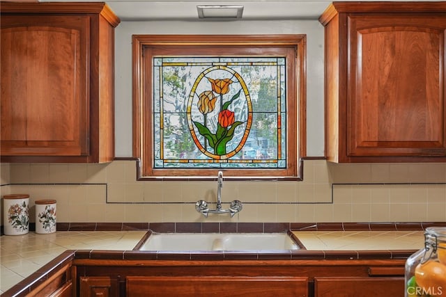 15731 Marlin Pl, Van Nuys, CA 91406 - kitchen with brown cabinetry, a sink, tile countertops, and tasteful backsplash