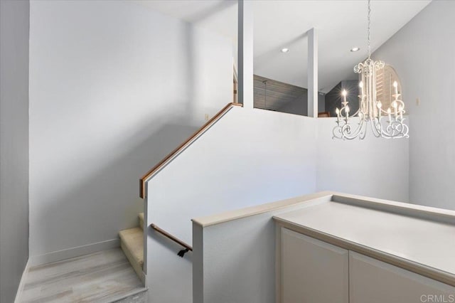 stairs with recessed lighting, baseboards, a chandelier, and wood finished floors