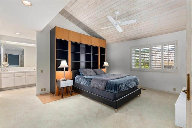 bedroom featuring lofted ceiling, baseboards, light colored carpet, recessed lighting, and connected bathroom