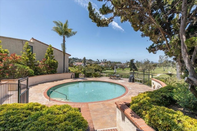 view of swimming pool with a fenced in pool and a patio