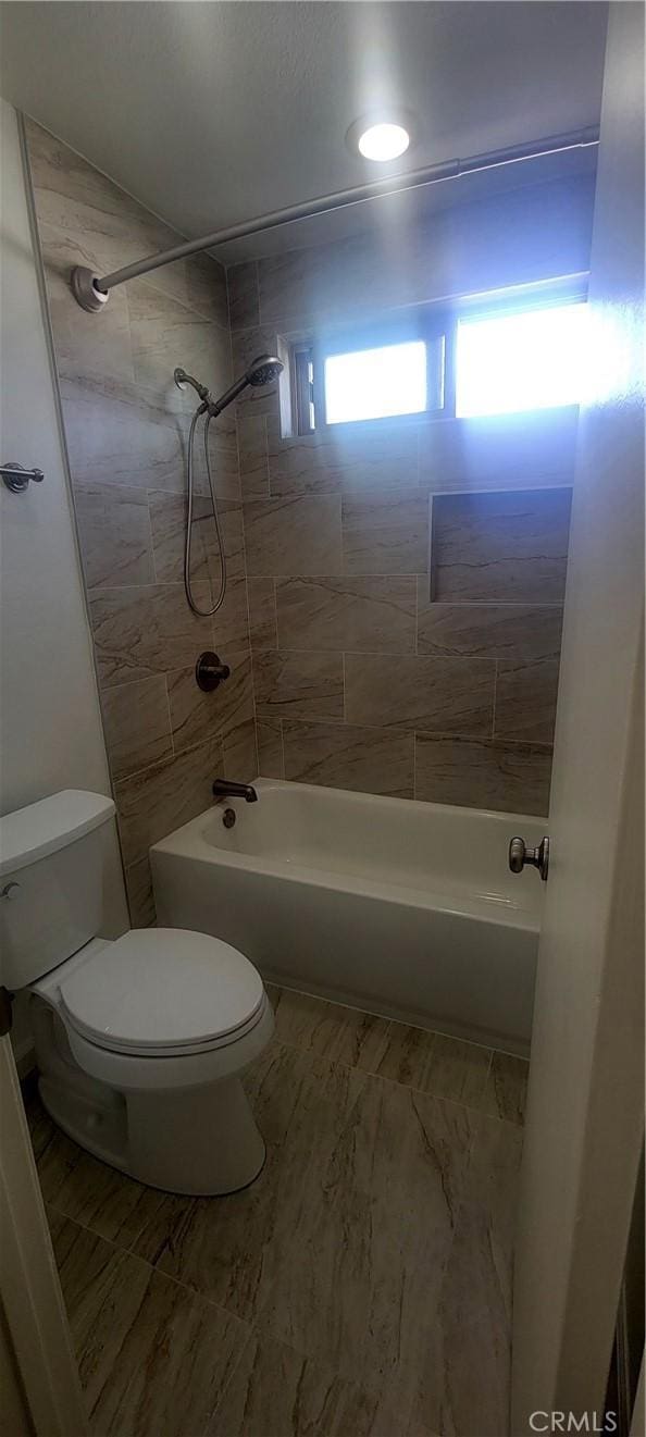 full bath featuring toilet and shower / washtub combination