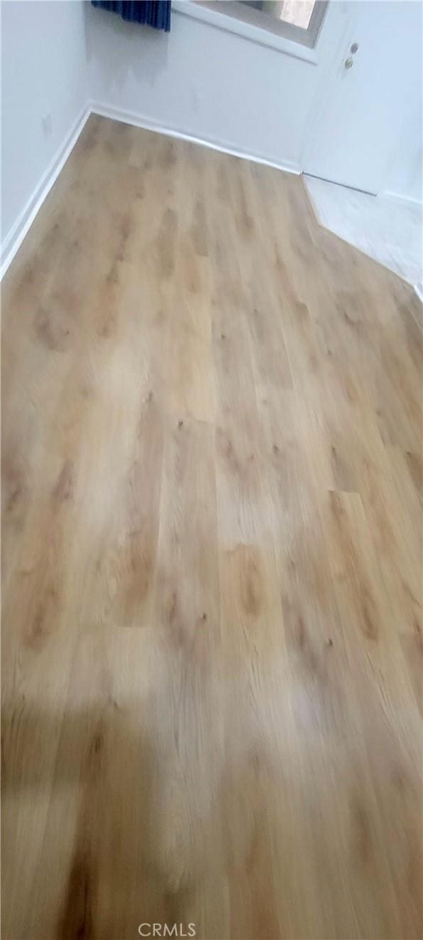 room details featuring baseboards and wood finished floors