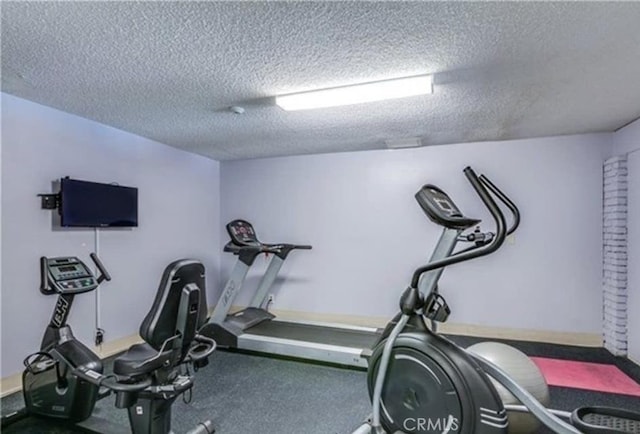 exercise room featuring a textured ceiling