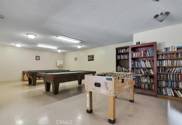 rec room featuring billiards, baseboards, concrete floors, and a textured ceiling