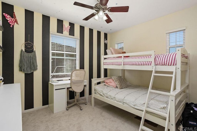 17011 Calle Trevino Unit 5, San Diego, CA 92127 - bedroom with light colored carpet, baseboards, ceiling fan, and wallpapered walls