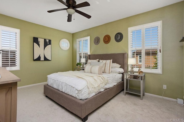 17011 Calle Trevino Unit 5, San Diego, CA 92127 - bedroom featuring a ceiling fan, baseboards, and light carpet