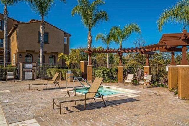 17011 Calle Trevino Unit 5, San Diego, CA 92127 - view of patio / terrace with a hot tub, a pergola, and fence