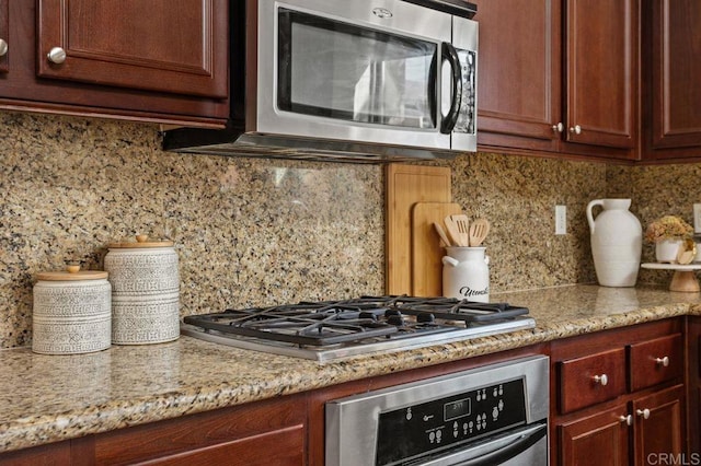 17011 Calle Trevino Unit 5, San Diego, CA 92127 - kitchen featuring backsplash, stainless steel appliances, and light stone countertops
