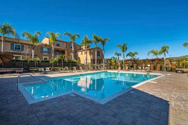 17011 Calle Trevino Unit 5, San Diego, CA 92127 - community pool with fence, a patio, and a residential view