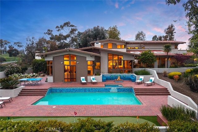 view of swimming pool with a hot tub, a patio, and a fenced in pool