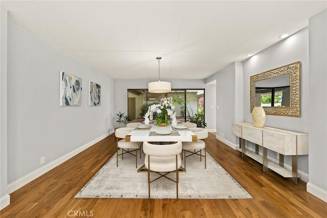 dining room with recessed lighting, baseboards, and wood finished floors