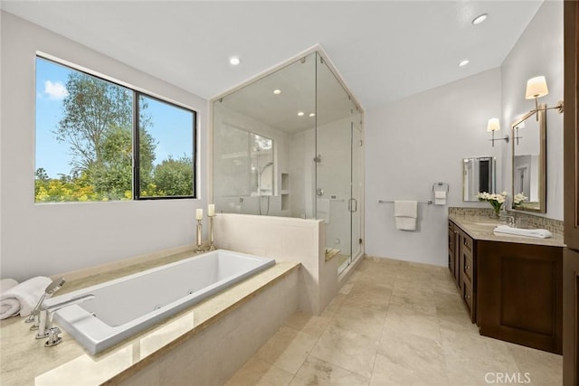 bathroom with recessed lighting, vanity, a stall shower, and a tub with jets