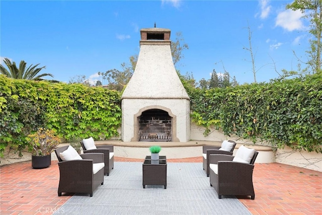 view of patio / terrace with an outdoor fireplace