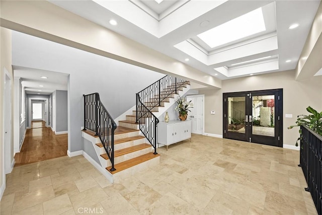 stairway with baseboards, stone tile floors, and recessed lighting