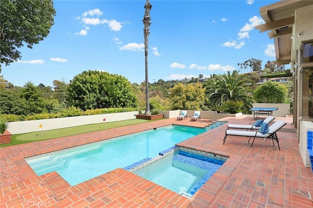 view of swimming pool featuring a patio and a pool with connected hot tub