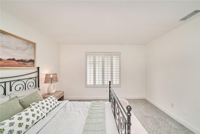carpeted bedroom with baseboards and visible vents