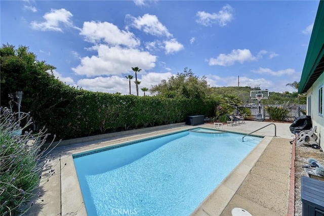 view of swimming pool with a fenced in pool and a patio