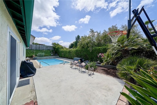 view of pool with a fenced in pool, a fenced backyard, and a patio area