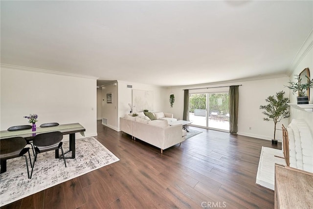 living area with baseboards, ornamental molding, and dark wood-type flooring