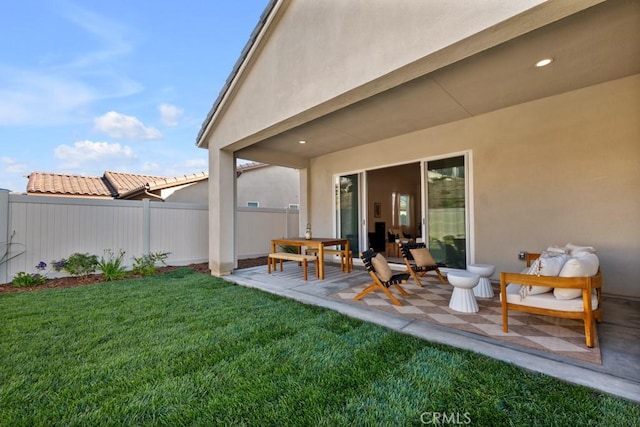 exterior space with a lawn, stucco siding, and fence