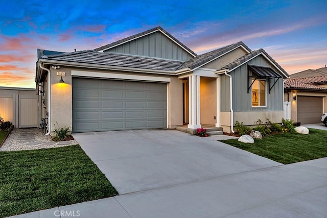 single story home featuring board and batten siding, driveway, a front lawn, and a garage