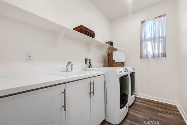 clothes washing area with baseboards, dark wood-type flooring, separate washer and dryer, a sink, and cabinet space