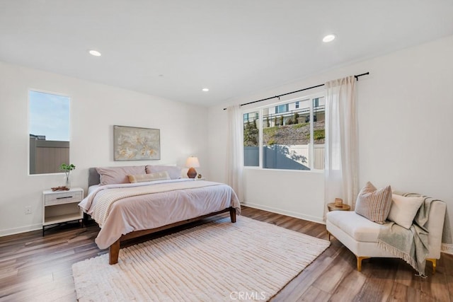 bedroom featuring baseboards, recessed lighting, and wood finished floors