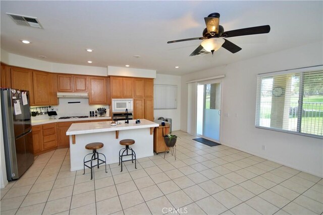 31105 Sunningdale Dr, Temecula, CA 92591 - kitchen featuring white appliances, under cabinet range hood, light countertops, a sink, and ceiling fan