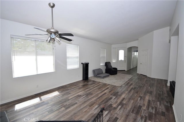 31105 Sunningdale Dr, Temecula, CA 92591 - unfurnished living room featuring arched walkways, ceiling fan, healthy amount of natural light, and dark wood finished floors