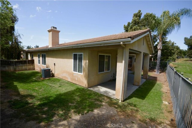 31105 Sunningdale Dr, Temecula, CA 92591 - rear view of house featuring stucco siding, a chimney, a patio, and central AC unit