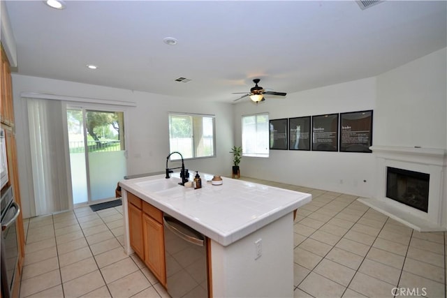 31105 Sunningdale Dr, Temecula, CA 92591 - kitchen featuring tile counters, dishwasher, light tile patterned floors, ceiling fan, and plenty of natural light