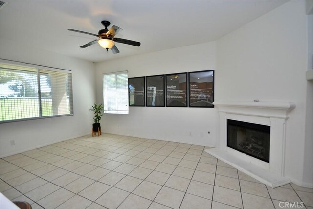 31105 Sunningdale Dr, Temecula, CA 92591 - unfurnished living room featuring ceiling fan, a glass covered fireplace, and tile patterned floors