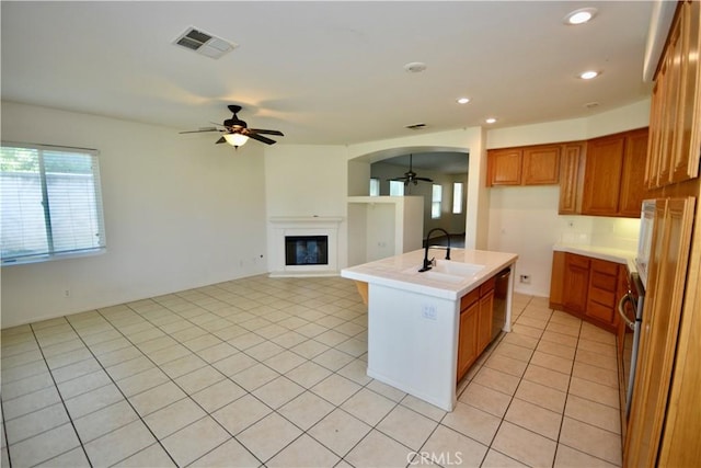 31105 Sunningdale Dr, Temecula, CA 92591 - kitchen featuring a ceiling fan, a sink, brown cabinetry, stainless steel dishwasher, and light countertops