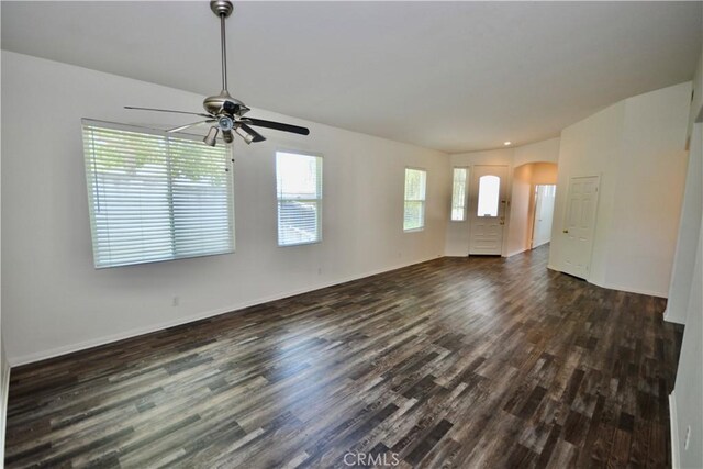 31105 Sunningdale Dr, Temecula, CA 92591 - empty room with dark wood-style flooring, ceiling fan, arched walkways, and baseboards