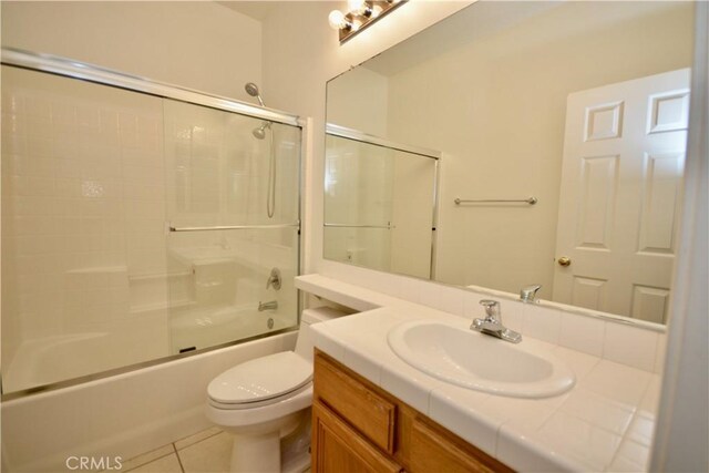 31105 Sunningdale Dr, Temecula, CA 92591 - full bathroom with vanity, toilet, tile patterned floors, and combined bath / shower with glass door
