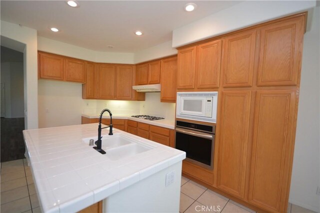 31105 Sunningdale Dr, Temecula, CA 92591 - kitchen featuring white appliances, tile countertops, under cabinet range hood, light tile patterned floors, and a sink
