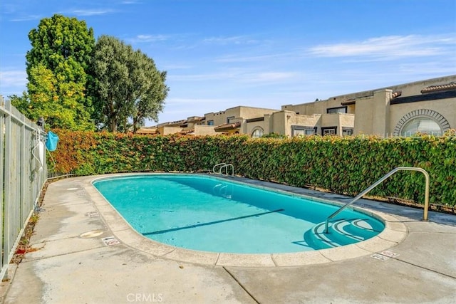 community pool featuring a fenced backyard
